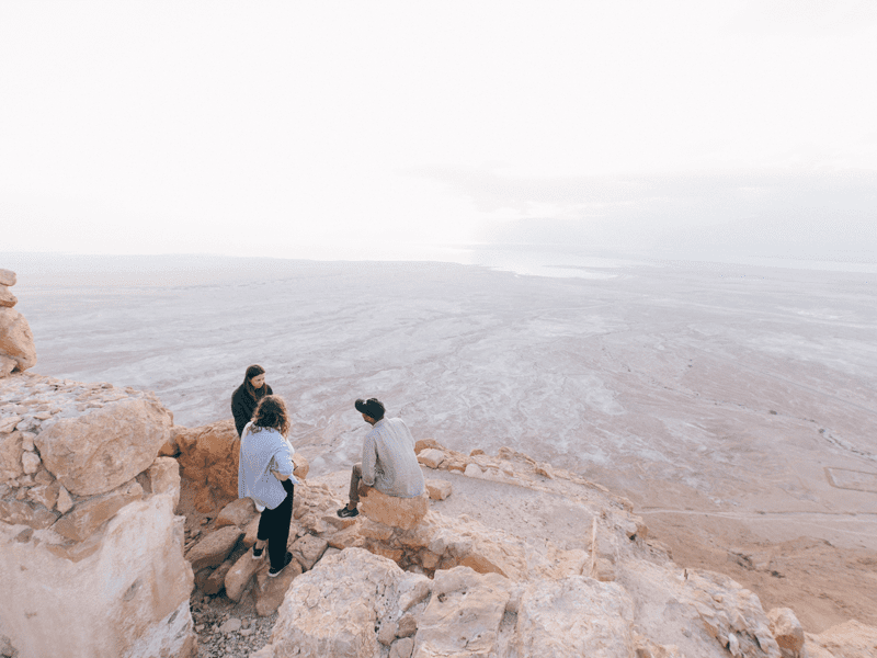 Three people together near cliff edge