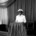 Captain Lucy Chacha smiling behind podium