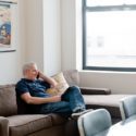 Man sitting on couch talking on phone