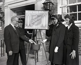 Women and men donating to red kettle