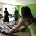 people exercising on treadmills and stationary bike