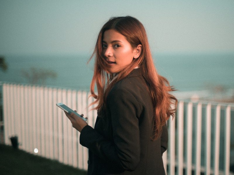 Woman on phone looking behind her