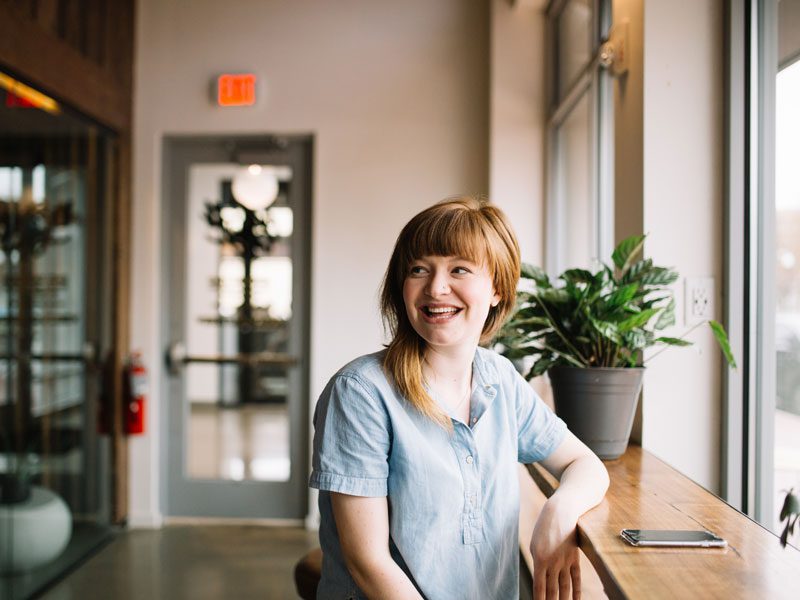 woman smiling at table