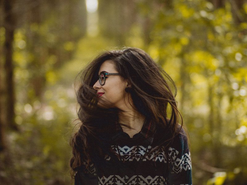 Woman looking over shoulder outside