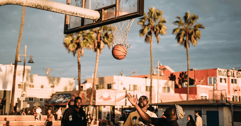 Men playing basketball during daytime