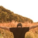 Person with arms spread outside