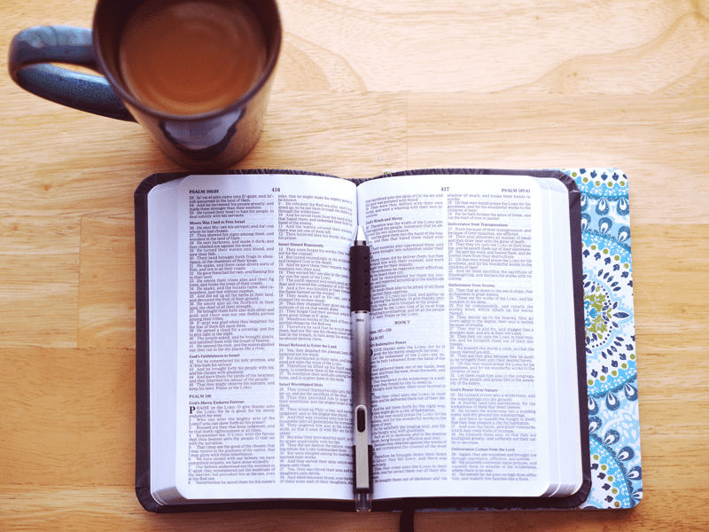 coffee next to open book and pen