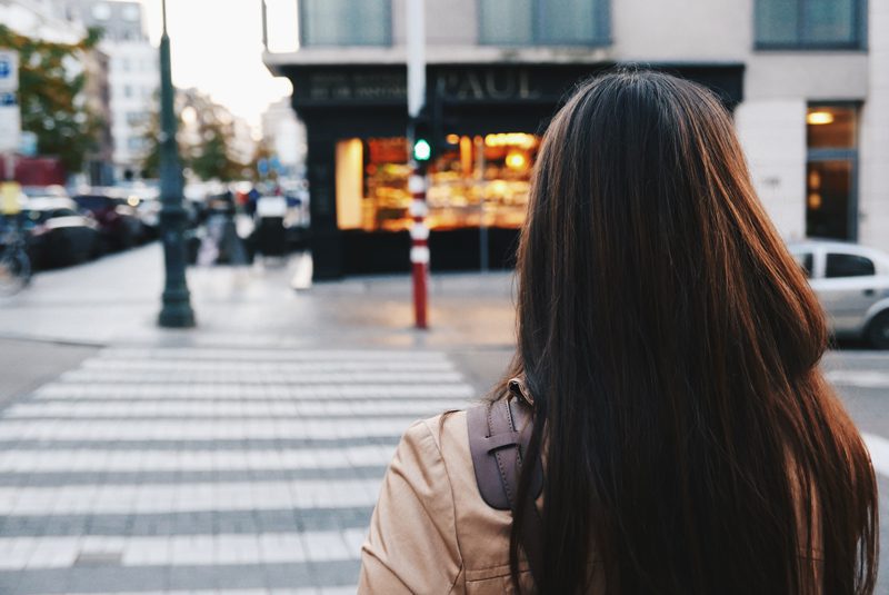 Female about to enter crosswalk on street