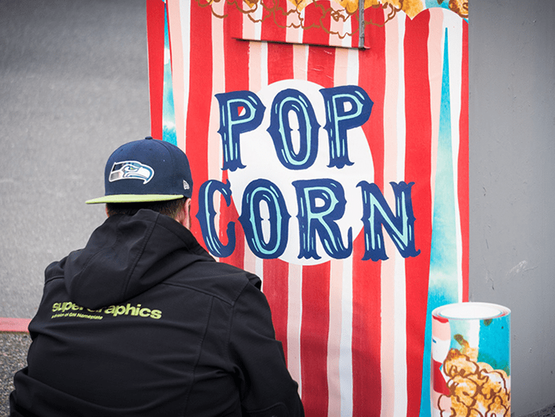 Large painting of popcorn bag outside