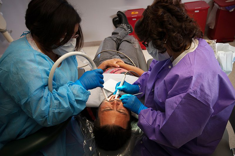 Dentists helping patient