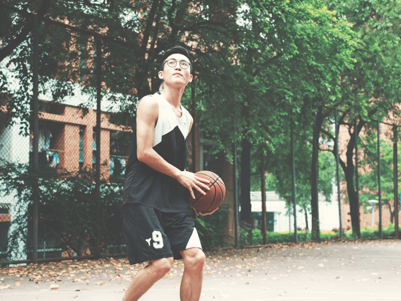 Boy playing basketball outside