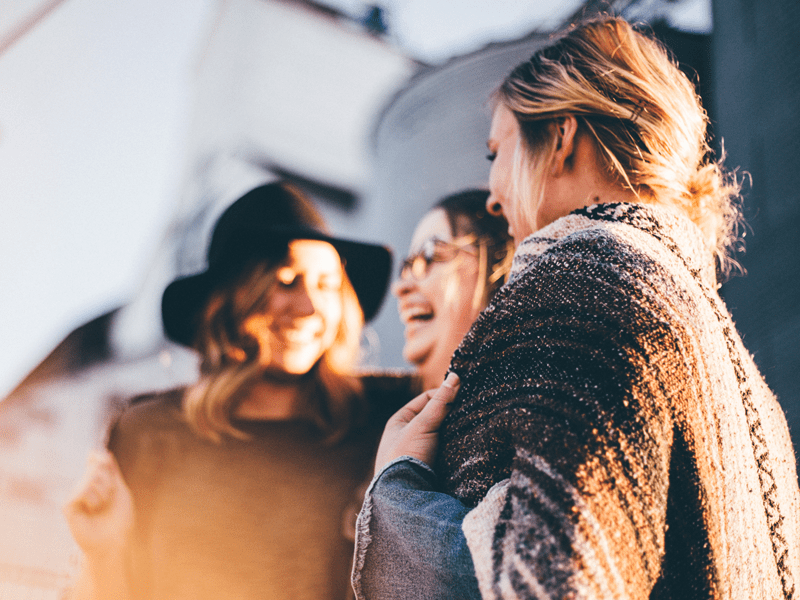 Three women laughing together