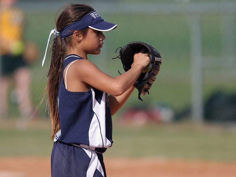 Young girl playing softball