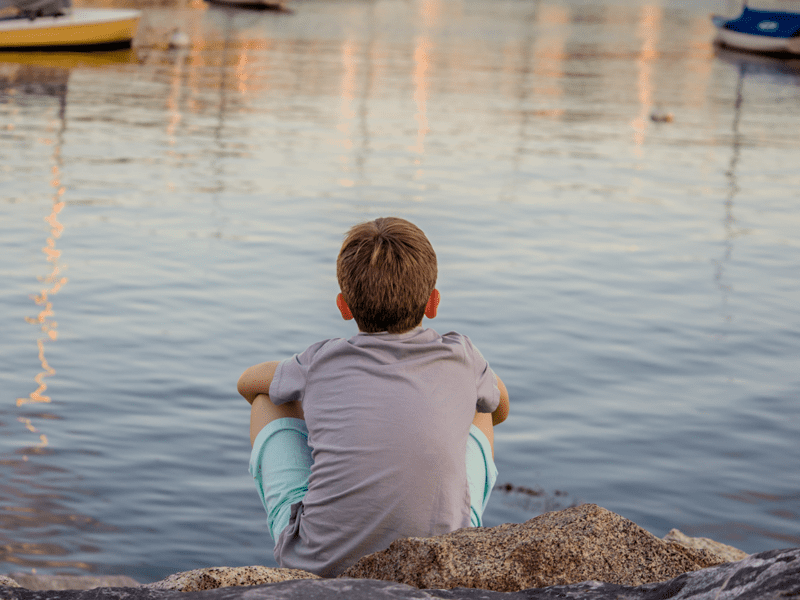 Child looking out at water