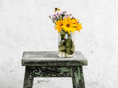 Flowers in vase on stool