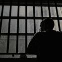 Man looking out window in dark room