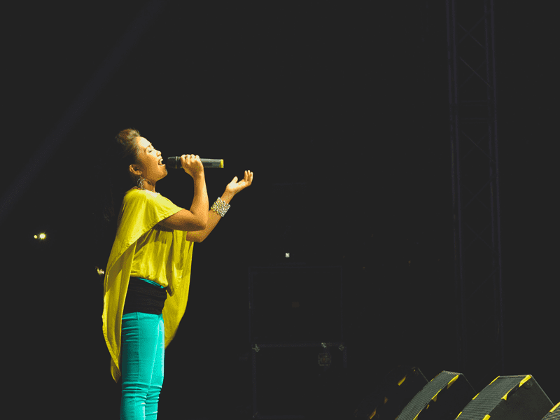 woman in yellow top singing