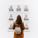 Woman looking at pictures on wall