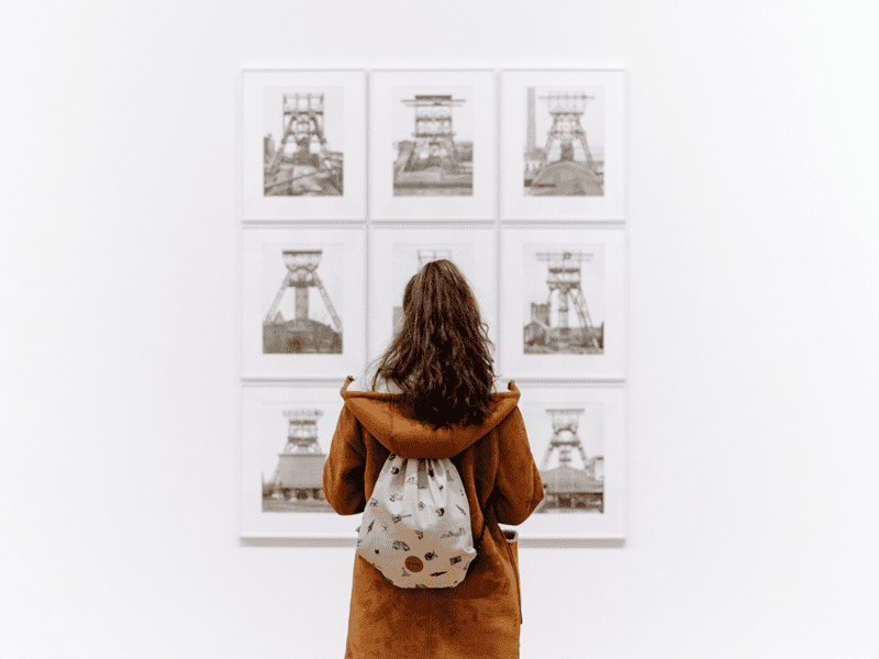 Woman looking at pictures on wall