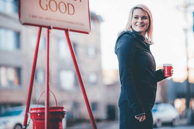 Salvation Army Bellringer in front of Kettle