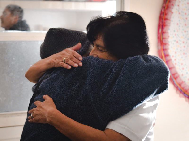 Staffer and resident hugging