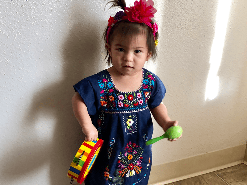 young female child holding instruments