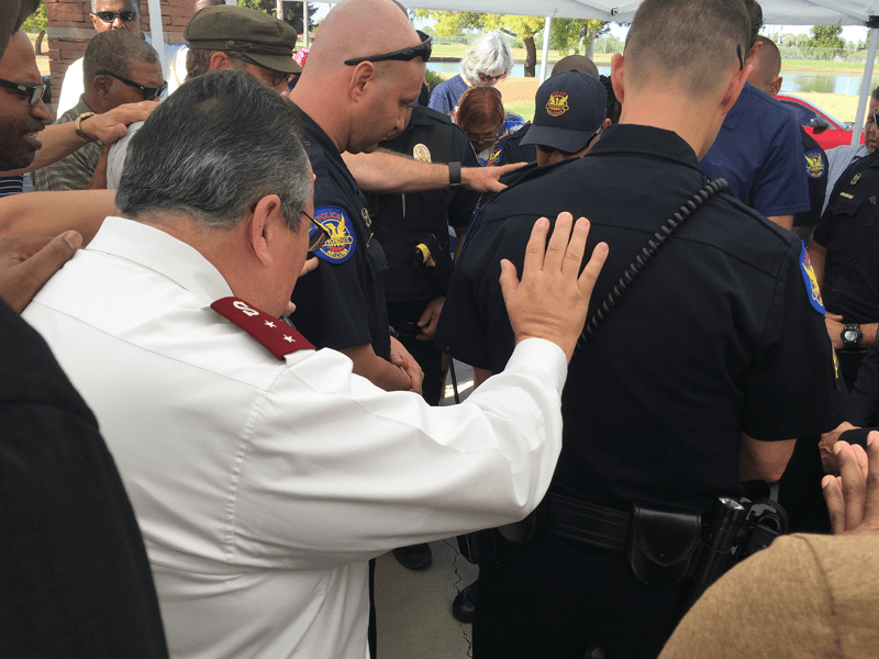 Salvation Army and Police Officers praying together 
