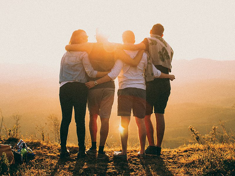 Group of people with arms around each other 