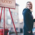 woman next to red kettle