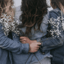 Three women with arms around each other