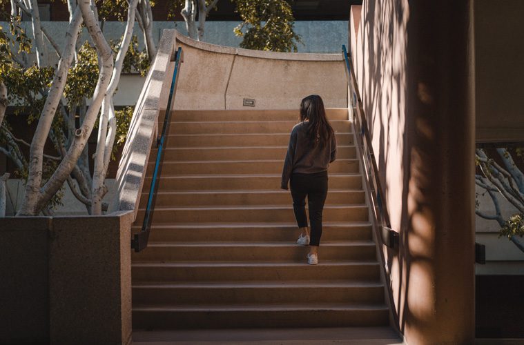 woman walking up stairs