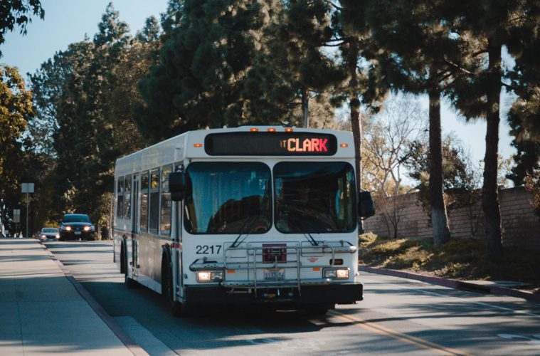 bus driving on road during daytime