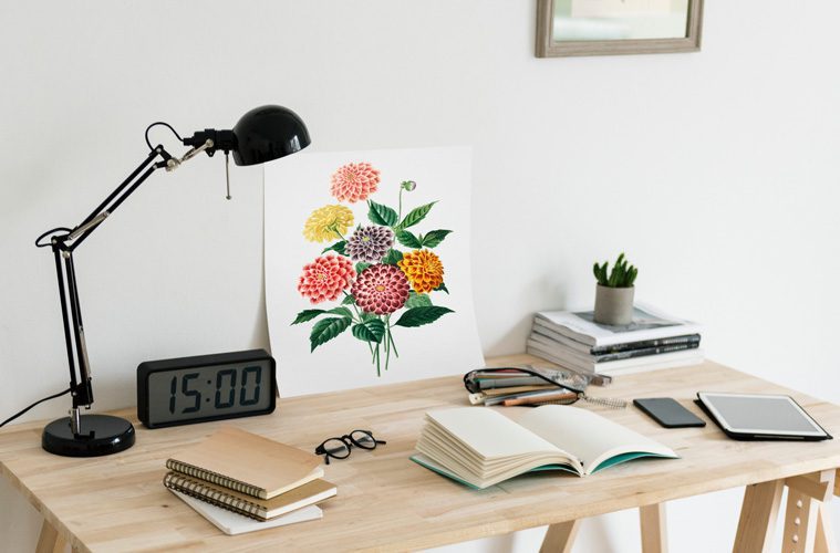 open book and painting on desk with lamp