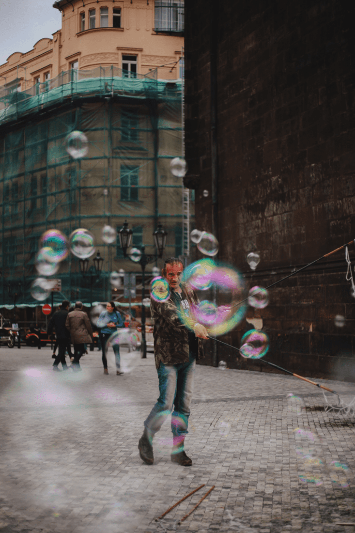 Man making bubbles in street