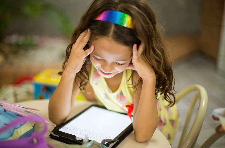 young girl looking at iPad