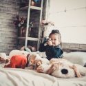 girl on bed with stuffed animals