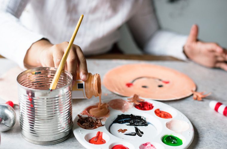 Person pouring paint onto palette