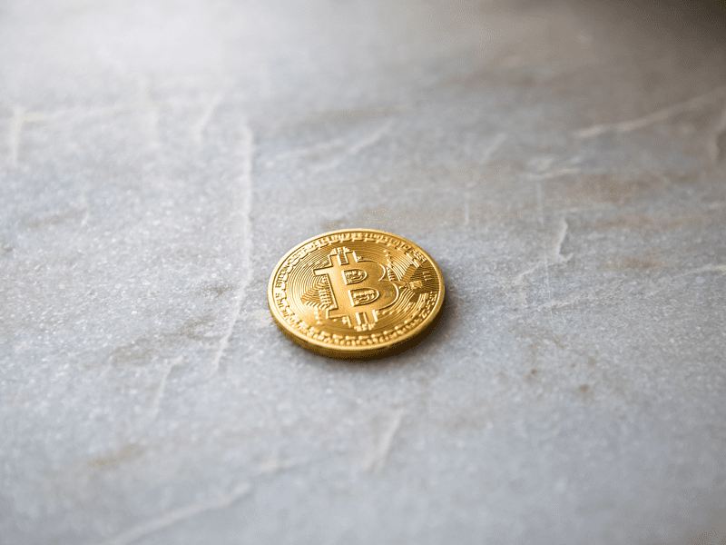 Closeup view of gold coin with bitcoin logo