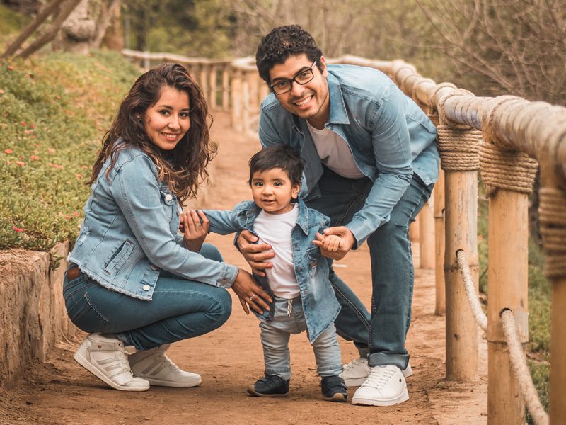 Husband and wife with child outsdie