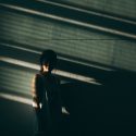 person standing alone with shadows covering them