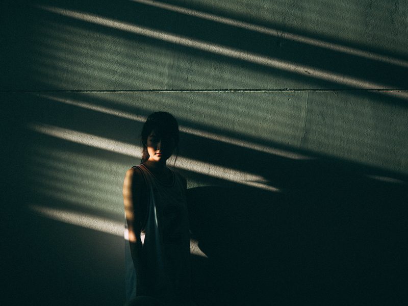 person standing alone with shadows covering them