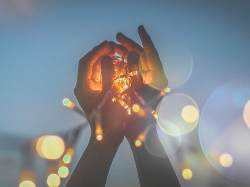 hands holding a small light