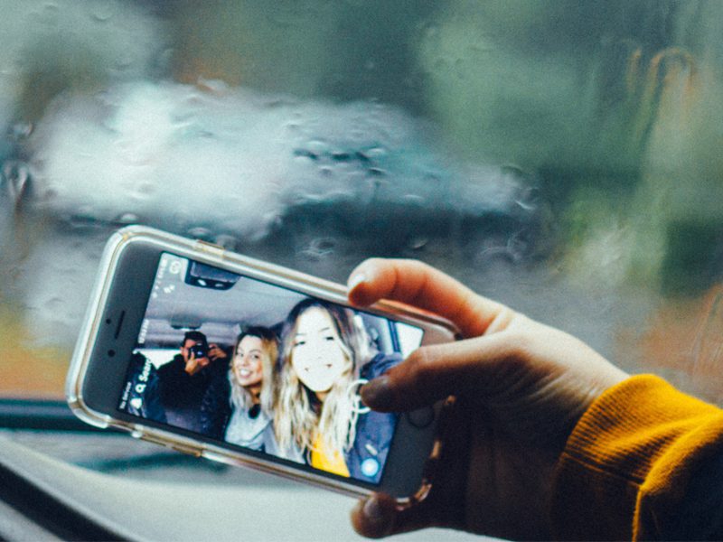 woman taking selfie with friends