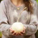 woman holding small pumpkin