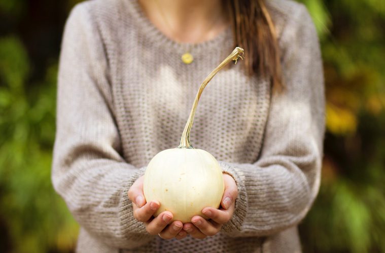 woman holding small pumpkin