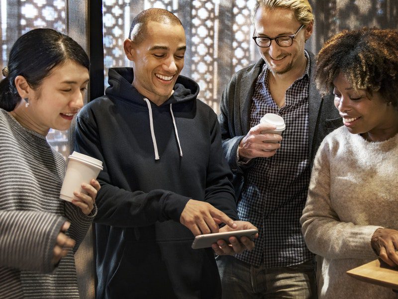 group of people watching something on persons phone