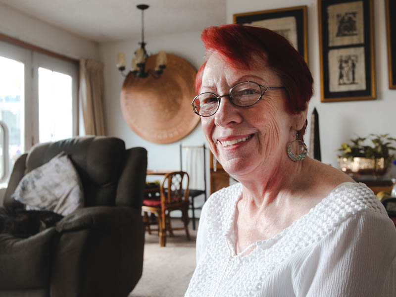 Older woman smiling inside her home