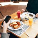 Two people eating together at table