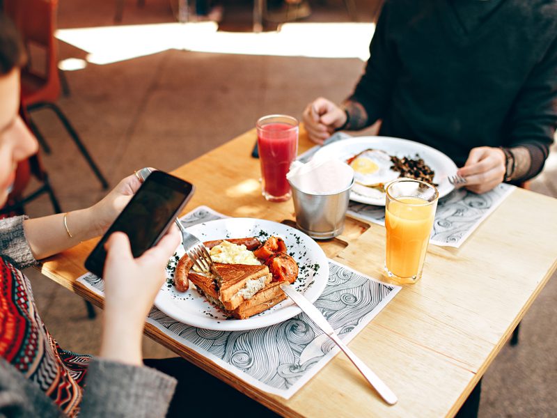 Two people eating together at table