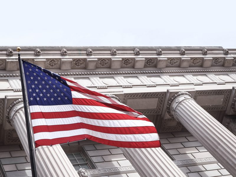 American Flag waving in front of columns